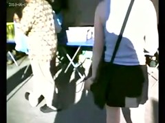 A public upskirt voyeur clip of a girl's bum in black thong