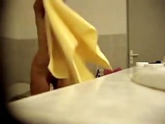 Naked babe towels off as a perv watches