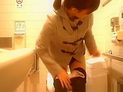 Asian woman caught in public toilet peeing
