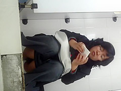 Chinese milf spied taking a piss