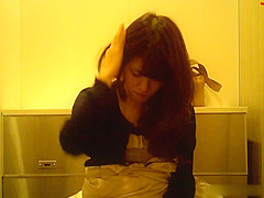 Asian girl and her cell phone in this toilet spy cam video