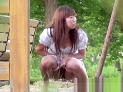 Tantalizing Japanese in skirt peeing behind bench in park