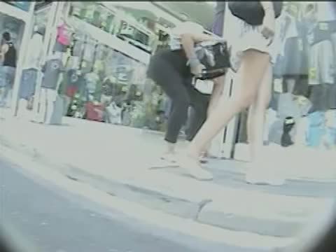 Sexy blond girl caught in a real street up skirt video.